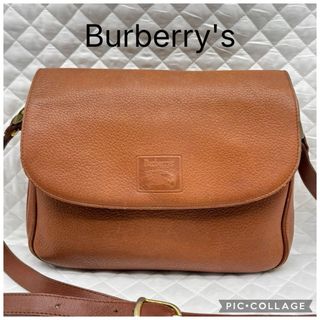 A blurred photograph of a leather shoulder bag